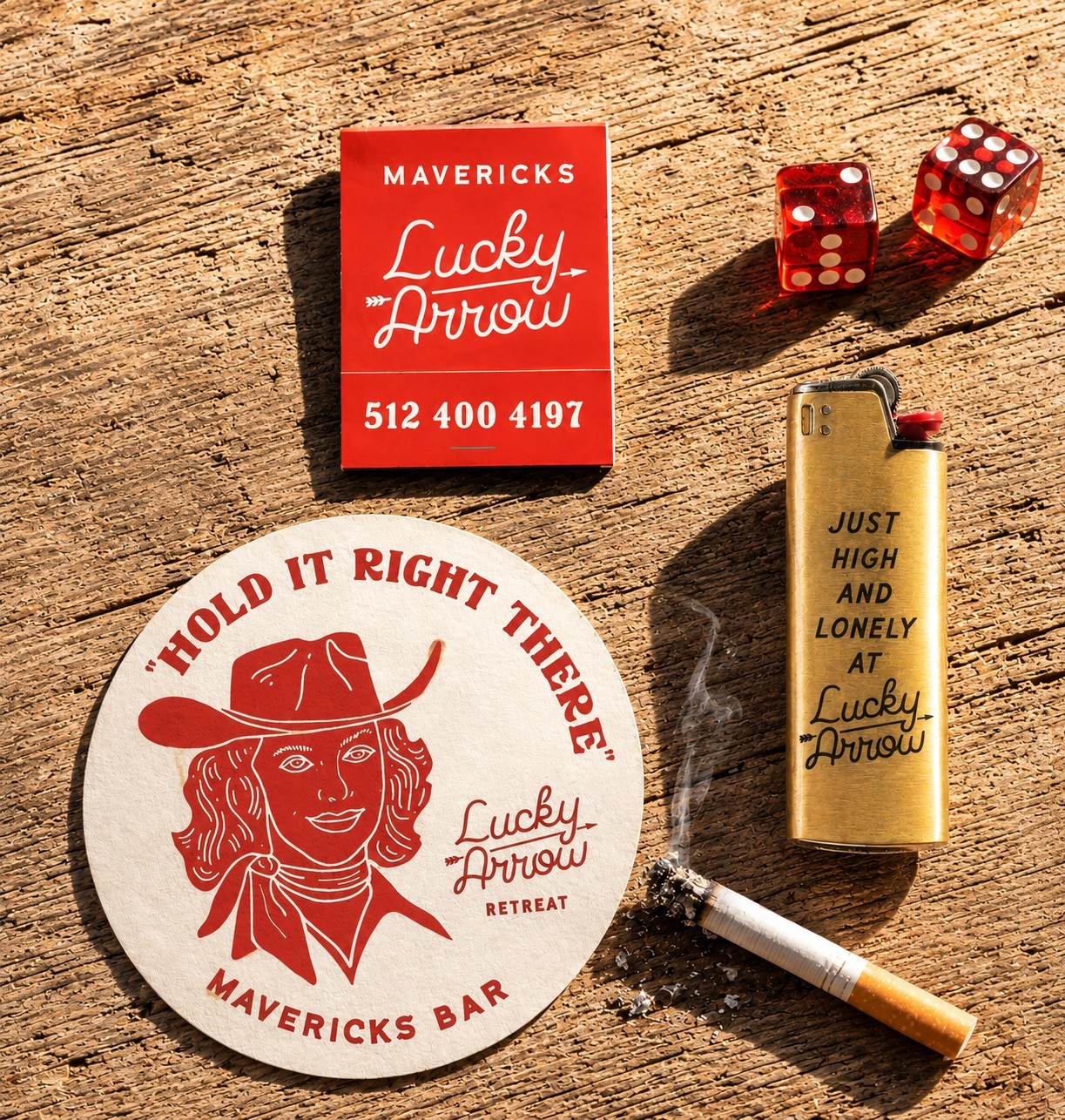 Lucky Arrow Retreat matchbook, coaster, lighter, and dice